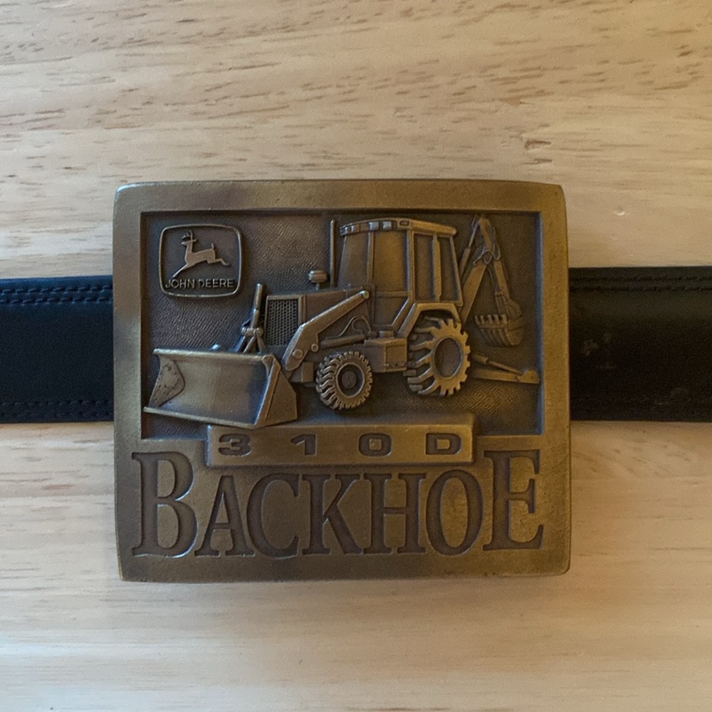 John Deere brass buckle- Featuring a 310D BACKHOE. Made in U. S. A.